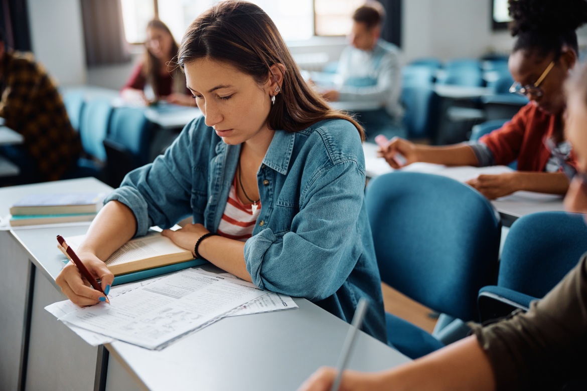 Female student learning during a class at university classroom.